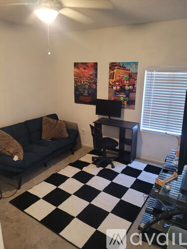 A black and white checkered rug is on the floor of a living room.