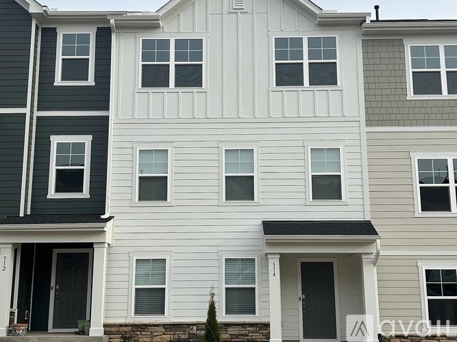 A row of houses with white and grey siding.