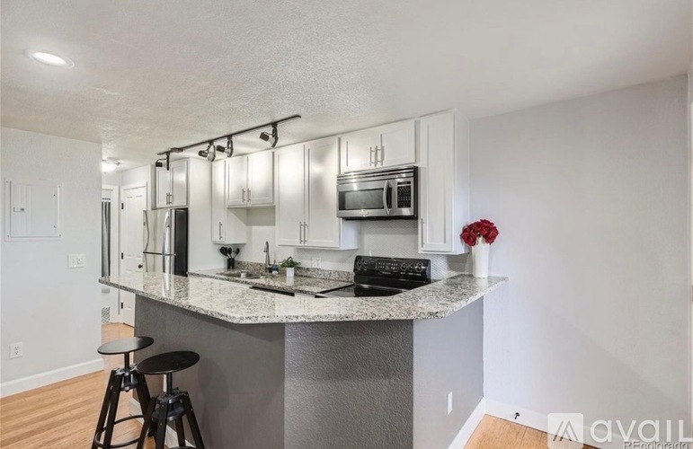 A kitchen with a granite countertop and a sink.