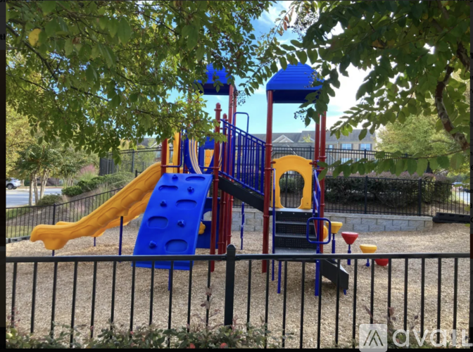 A playground with a blue and yellow slide.