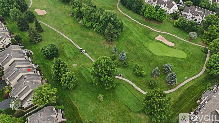 A golf course surrounded by houses.
