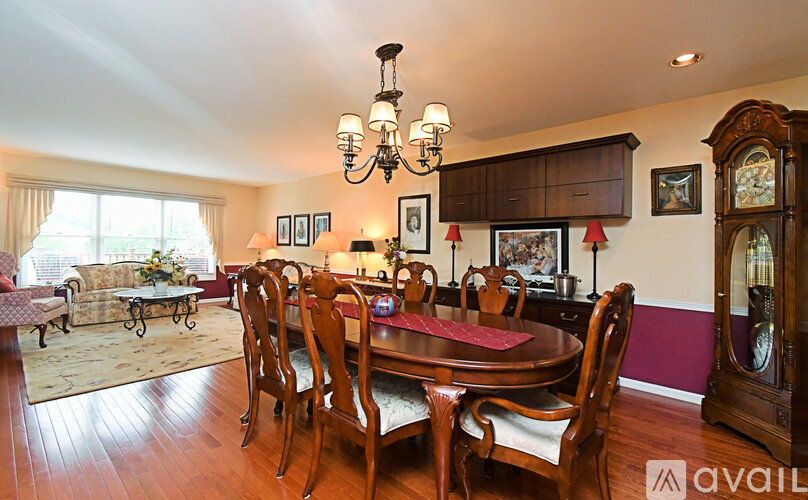 A dining room with a wooden table and chairs.