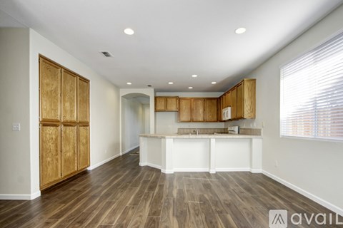 A kitchen with wooden cabinets and a white island.