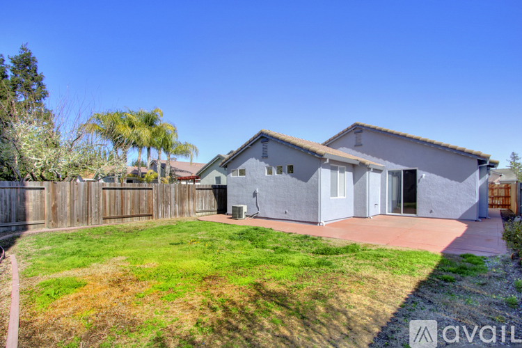 A house with a grey exterior is available for sale.