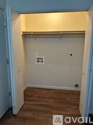 A room with a light switch and a white wall.