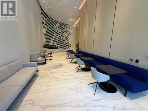 A white and blue lounge area with a black table and chairs.