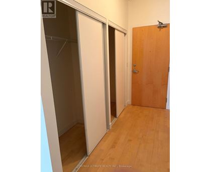 A room with a wooden door and a sliding glass door.