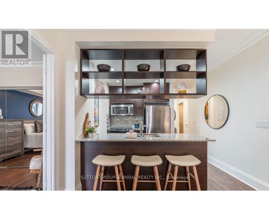 A modern kitchen with a bar stool and a countertop.