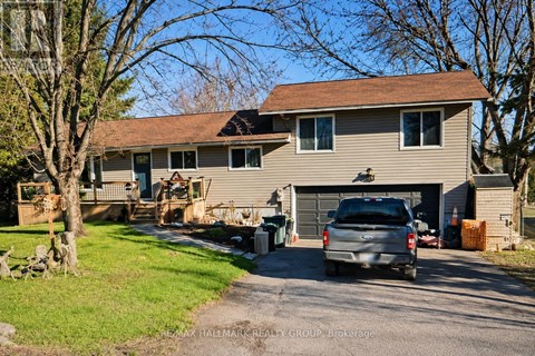 A house with a garage and a car parked in front.