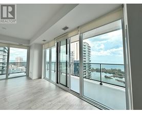 A spacious room with a view of the cityscape and water.