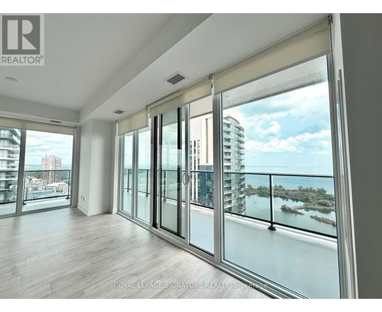 A spacious room with a view of the cityscape and water.