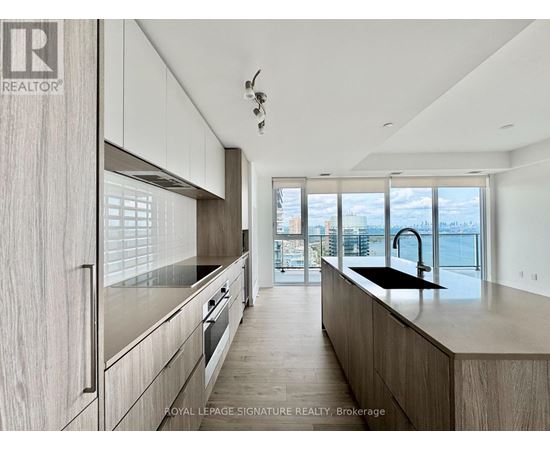 A modern kitchen with wooden cabinets and a view of the city.