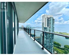 A balcony with a view of a cityscape and water.