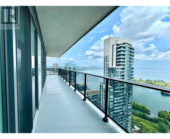 A balcony with a view of a cityscape and water.