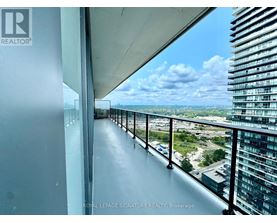 A balcony with a view of the cityscape and a clear sky.