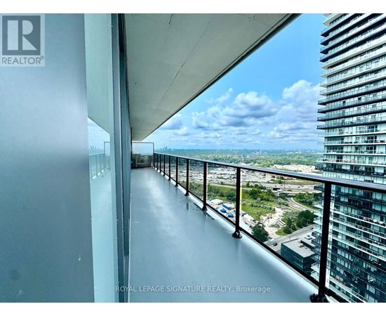 A balcony with a view of the cityscape and a clear sky.
