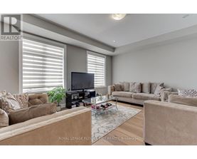 A living room with a television, couches, and a coffee table.