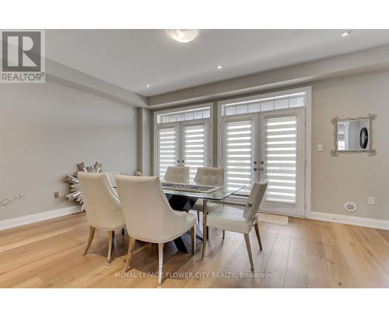 A dining room with a table and chairs.