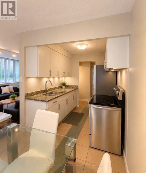 A modern kitchen with white cabinets and a stainless steel dishwasher.