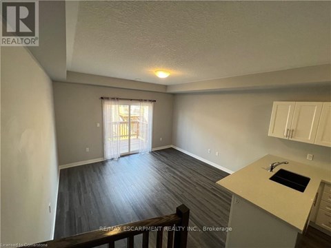 A room with a sink and a window with curtains.