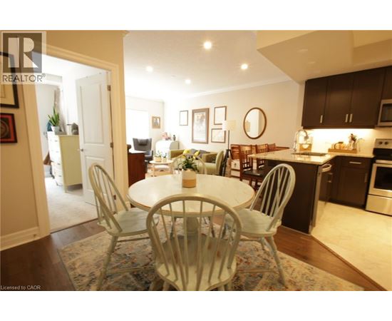 A dining room with a white table and chairs.