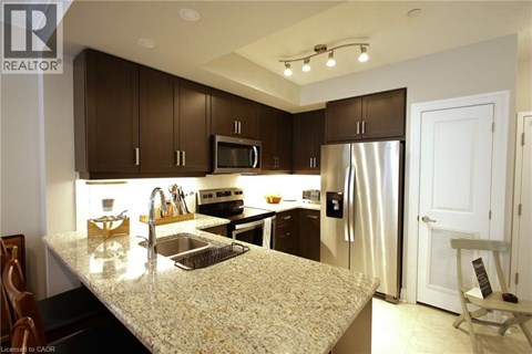 A kitchen with brown cabinets and a granite countertop.