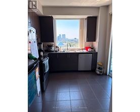 A kitchen with a view of the city.