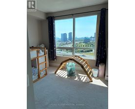 A room with a view of the city skyline through large windows.