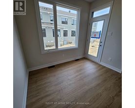 A room with a view of a building outside the window.