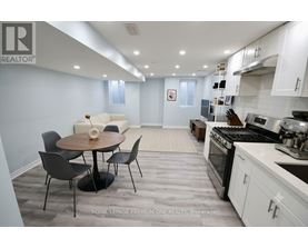 A modern kitchen with a dining table and chairs.