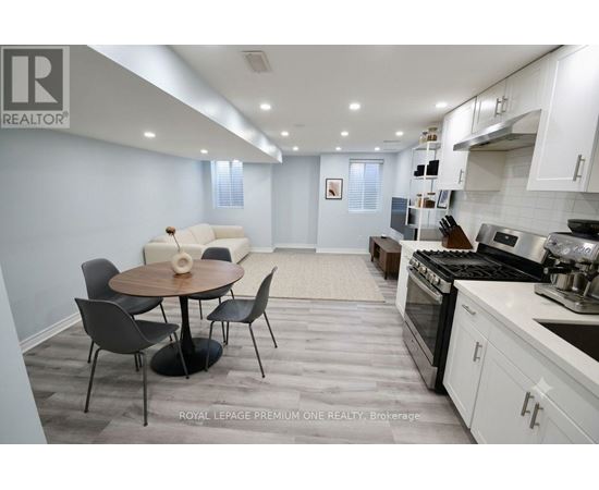 A modern kitchen with a dining table and chairs.