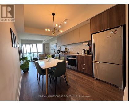 A kitchen with a table and chairs in the middle of the room.