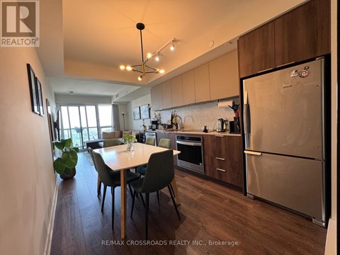 A kitchen with a table and chairs in the middle of the room.