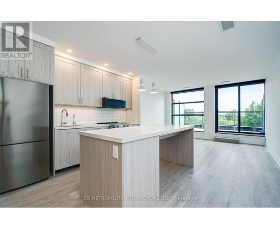 A modern kitchen with wooden cabinets and a central island.