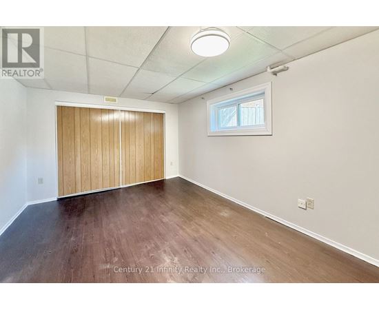 A room with a wooden floor and a sliding door.
