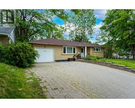 A house with a driveway in front of it.