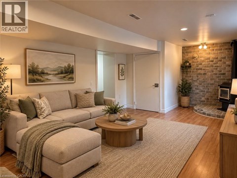 A living room with a couch, a coffee table, and a painting on the wall.