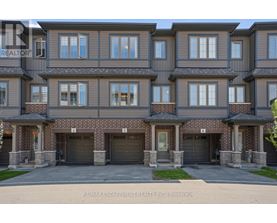 A large, multi-story residential building with a brick facade and multiple garage doors.