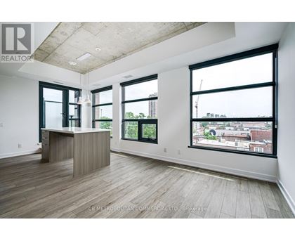 A spacious office room with a desk and large windows overlooking a cityscape.