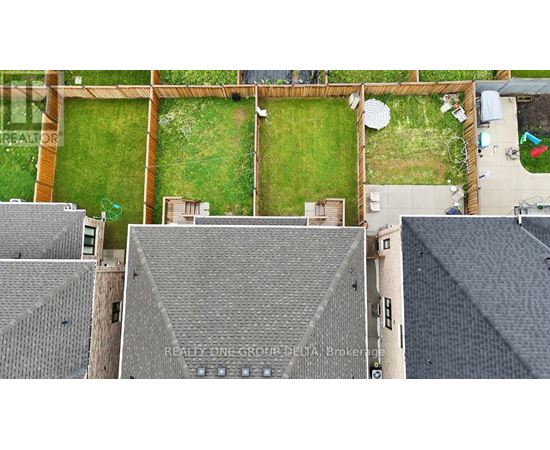 A bird's eye view of a rooftop of a building with a sign that says REALTY ONE GROUP DELTA Brokerage.