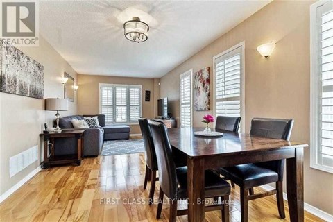 A dining room with a wooden table and chairs.