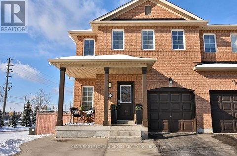 A house with a black front door and a brick facade.