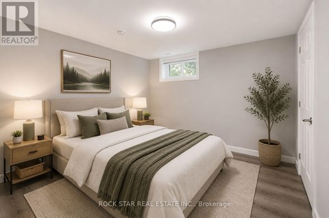 A bedroom with a large bed and a potted plant.