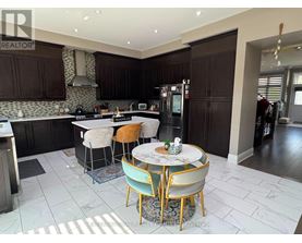 A kitchen with a table and chairs in the middle of the room.