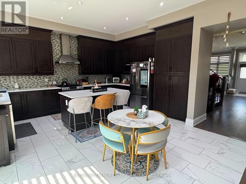 A kitchen with a table and chairs in the middle of the room.