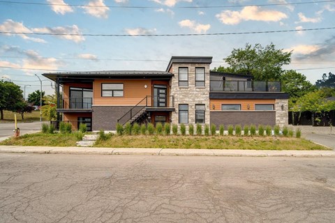 A two-story house with a brown and orange exterior.