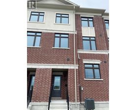 A red brick building with a black door and windows.