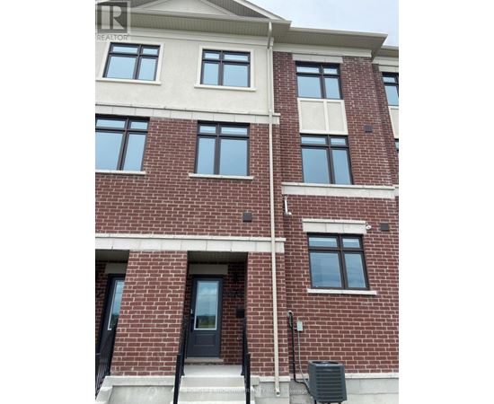 A red brick building with a black door and windows.