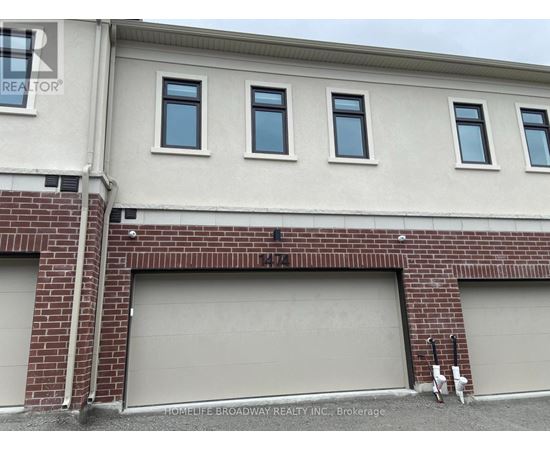 A building with a sign that says "HOMELIFE BROADWAY REALTY INC. Brokerage" in front of it.