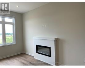 A white fireplace in a room with a window.
